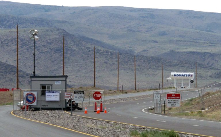 FILE-This Aug. 1, 2014 file photo shows security guards at the gate to the site Tahoe Reno Industrial Center about 15 miles east of Reno, Nevada. Tesla Motors is considering the site as one of two, or possibly three, finalists where it will build a $5 billion factory to make batteries for a new model of electric car. (AP Photo/Scott Sonner, File)