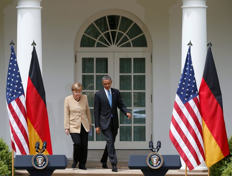 President Obama and German Chancellor Angela Merkel arrive for their joint news conference in the Rose Garden of the White House in Washington, Friday. (AP/Charles Dharapak)