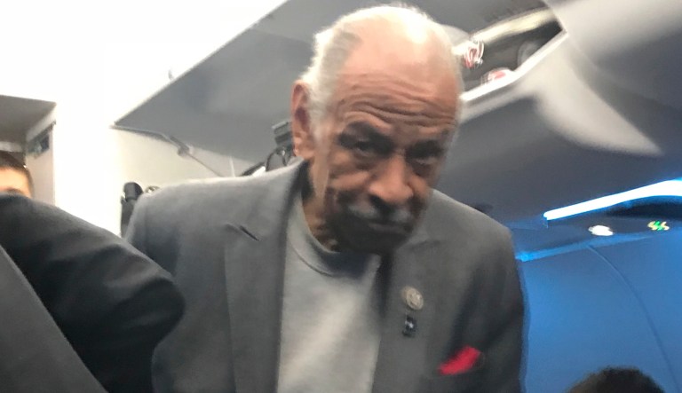 Rep. John Conyers is seen on a plane to Detroit on Tuesday, Nov. 28, 2017. Sam Riddle, a family spokesman and political consultant, said the 88-year-old was admitted to the hospital recently and is resting comfortably. (Dennis Lennox/Twitter via AP)
