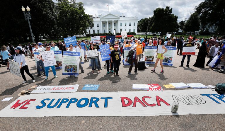 Supporters of Deferred Action for Childhood Arrivals program (DACA), layout a banner as they demonstrate on Pennsylvania Avenue in front of the White House in Washington, Sunday, Sept. 3, 2017. After months of dragging his feet, President Donald Trump will announce on Tuesday his plans for DACA program, which has given nearly 800,000 young immigrants the ability to work legally in the country and a reprieve from deportation. (AP Photo/Pablo Martinez Monsivais)