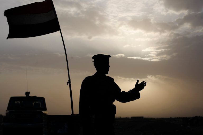A Yemeni soldier stops vehicles at a checkpoint on a road leading to the city of Amran, about 45 miles north of the capital, Sanaa, Yemen, Wednesday, July 9, 2014. Fighters from a Yemeni Shiite rebel group took control Tuesday of Amran, a northwestern city where they have been fighting for weeks with conservative Sunnis from one of the country's largest tribes, government and military officials said on Tuesday. (AP Photo/Hani Mohammed)