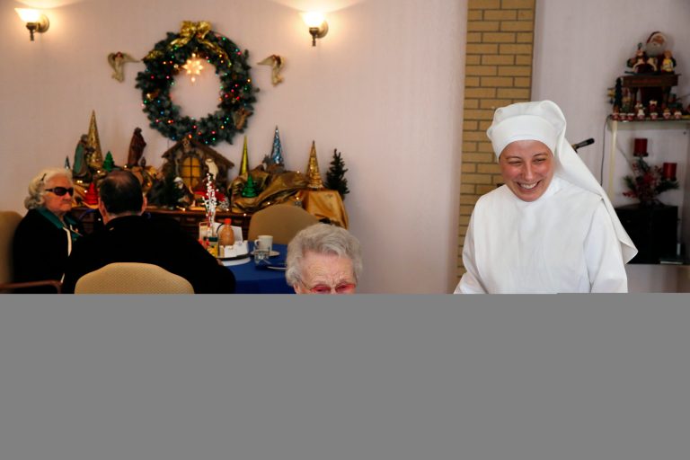 Sister Mary Grace visits with a resident in the dining room at the Mullen Home for the Aged, run by Little Sisters of the Poor, in Denver, Colo., on Jan. 2. Acting at the request of Little Sisters of the Poor, Justice Sonia Sotomayor onDec. 31, 2013, temporarily blocked the Obama administration from forcing some religious-affiliated groups to provide health insurance coverage of birth control or face penalties as part of the Affordable Care Act. (AP Photo/Brennan Linsley)