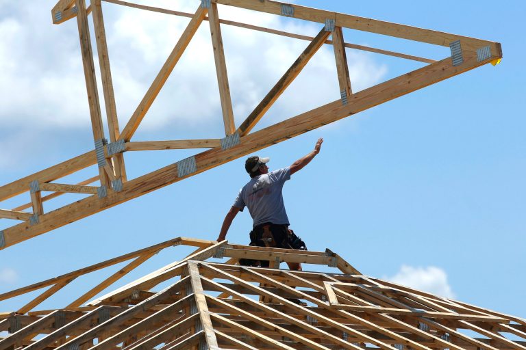 In this July 17, 2014 photo, construction workers build a commercial complex in Springfield, Ill.  The Conference Board reports on its August index of leading economic indicators, which is designed to predict the economy's future health, on Friday, Sept. 19, 2014. (AP Photo/Seth Perlman)