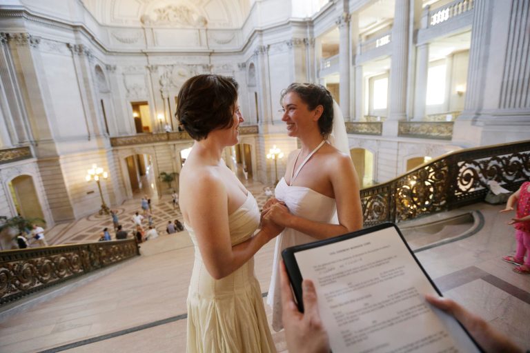 Cynthia Wides, center right, and Elizabeth Carey exchange wedding vows at City Hall in San Francisco, Saturday, June 29, 2013. (AP Photo/Marcio Jose Sanchez)