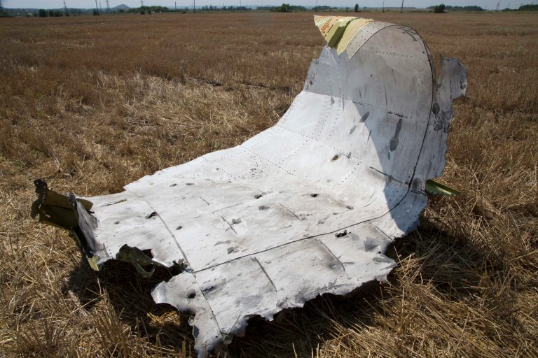 A piece of wreckage from the Malaysia Airlines jet downed over Ukraine. The piece is seen near Petropavlivka village, Donetsk region, eastern Ukraine Wednesday, July 23, 2014. The crash site, in territory held by the pro-Russian separatists accused by the Ukrainian government of shooting the plane down with a missile, remained unsecured five days after the disaster _ another source of frustration among foreign governments concerned about establishing the facts.  (AP Photo/Dmitry Lovetsky)