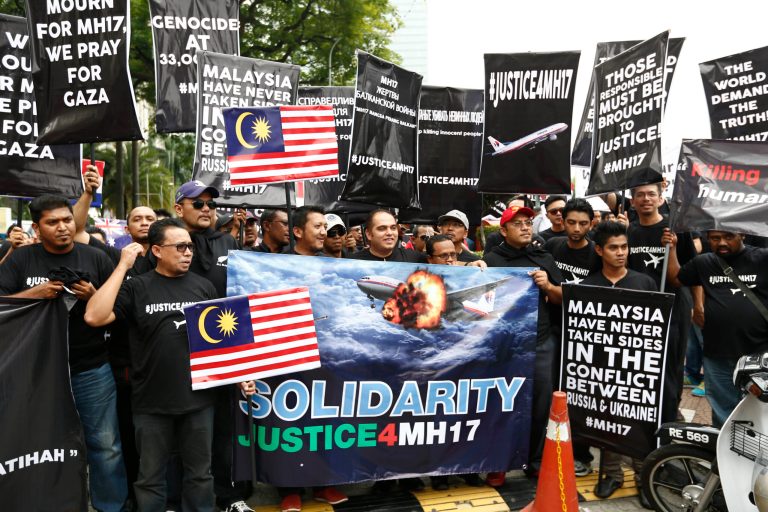Protesters stage a rally in front of Ukraine embassy in Kuala Lumpur, Malaysia, Tuesday, July 22, 2014. Protesters marched on the Russian embassy and Ukraine embassy in Kuala Lumpur on Tuesday, waving placards and demanding justice for the victims of the Malaysia Airlines flight that was shot down over Ukraine last week. (AP Photo/Vincent Thian)