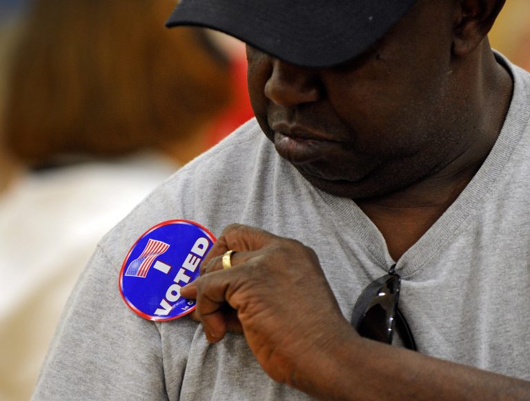 Ricky Tyler puts his 'I Voted' sticker on after casting his ballot at John Fremont Middle School on November 6, 2012 in Las Vegas, Nevada. Voting is underway in the battleground state of Nevada as President Barack Obama and Republican nominee former Massachusetts Gov. Mitt Romney remain in a virtual tie in the national polls. (Photo by David Becker/Getty Images)