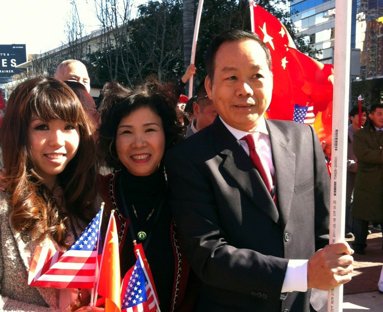 FILE - In this Feb. 16, 2012 file photo released by Anna Wu, American businessman Vincent Wu, right, poses for a photo with his wife Yip Lai Fong, center, and daughter Anna Wu as they wait to welcome China's then-Vice President Xi Jinping on his visit to Los Angeles, Calif. Wu stood trial in China on Monday, Feb. 10, 2014 for allegedly heading a violent mob that kidnapped rivals and operated illegal casinos, charges he's said he was tortured into confessing. Authorities in southern China have accused Wu of gang crimes but his family and lawyers say he's a law-abiding businessman whose rivals have framed him to seize his assets. Wu's lawyers urged a court in the southern city of Guangzhou to recognize the defendant's American citizenship as he and more than two dozen associates stood trial.  (AP Photo/File)