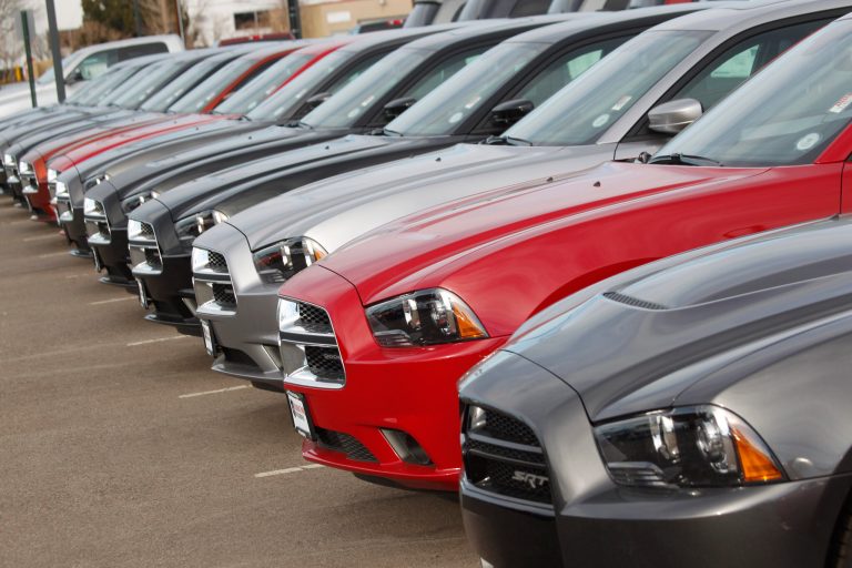 FILE - In this Sunday, Jan. 20, 2013, file photo, a line of unsold 2013 Chargers sits at a Dodge dealership in Littleton, Colo. Chrysler is recalling nearly 907,000 Chrysler, Dodge and Jeep SUVs and cars for failing alternators and heated power mirrors that can cause minor fires. The largest of the recalls issued on Thursday, Oct. 16, 2014, covers nearly 470,000 Jeep Grand Cherokees, Chrysler 300s, and Dodge Chargers, Challengers and Durangos from 2011 through 2014. The alternators can fail, causing the 3.6-liter V6 engines to stall unexpectedly. (AP Photo/David Zalubowski, File)