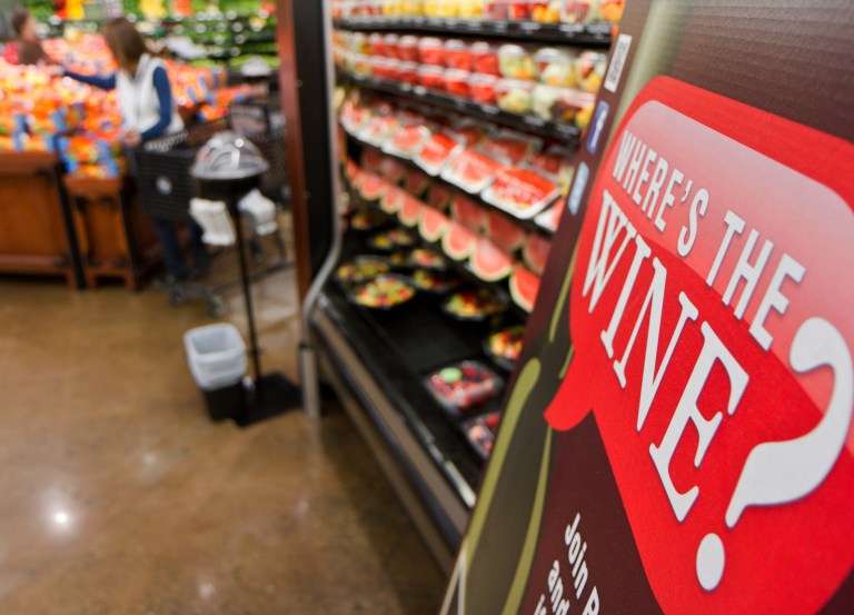   In this Friday, Nov. 30, 2012 file photo, a sign in a Kroger supermarket in Nashville, Tenn., urges shoppers to sign up for a group urging lawmakers to change state law that limits wine sales to liquor stores. (AP Photo/Erik Schelzig)  