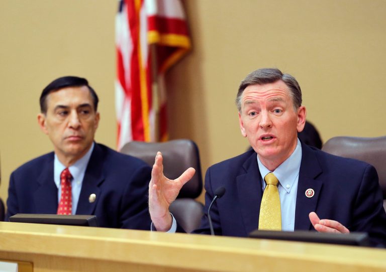 House Oversight and Government Reform Committee Chairman Darrell Issa, R-Calif., left, listens as U.S. Rep. Paul Gosar, R-Ariz., speaks during a Congressional Field Hearing on the Affordable Care Act's impact on Americans, Friday, Dec. 6, 2013, in Apache Junction, Ariz. (AP Photo/Matt York)