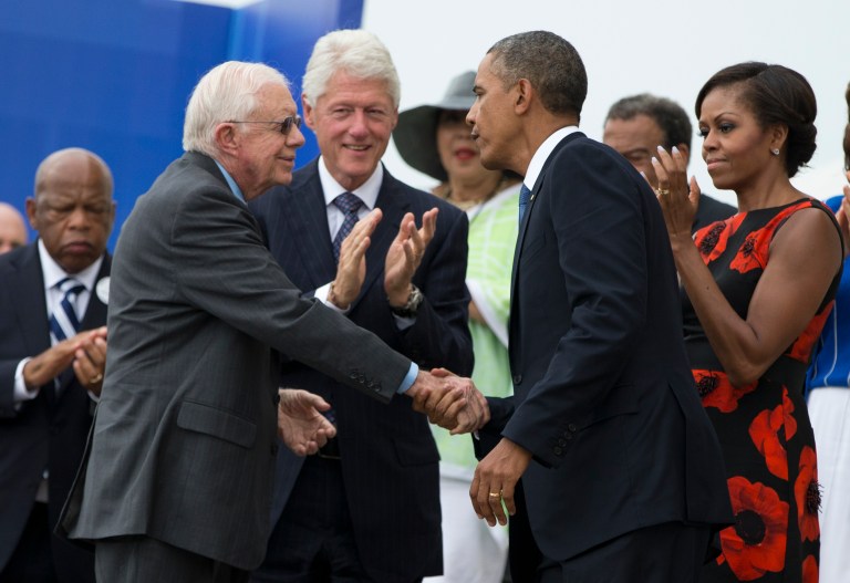 President Barack Obama shakes hands with former President Jimmy Carter, left, during a ceremony commemorating the 50th anniversary of the March on Washington, Wednesday, Aug. 28, 2013, at the Lincoln Memorial in Washington. (AP Photo/Evan Vucci)