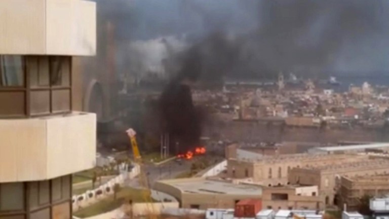 In this image made from video posted by a Libyan blogger, the Cortinthia Hotel is seen under attack in Tripoli, Libya, Tuesday, Jan. 27, 2015. Gunmen stormed the luxury hotel in the Libyan capital of Tripoli on Tuesday, killing several foreigners and guards, officials said. The attack, which included a car bombing, struck the hotel, which sits along the Mediterranean Sea. The blogger, @AliTweel, captured the moments shortly after the blast, when flames rose up from outside the hotel, appearing to be from the aftermath of the car bomb. (AP Photo/ @AliTweel via AP video)