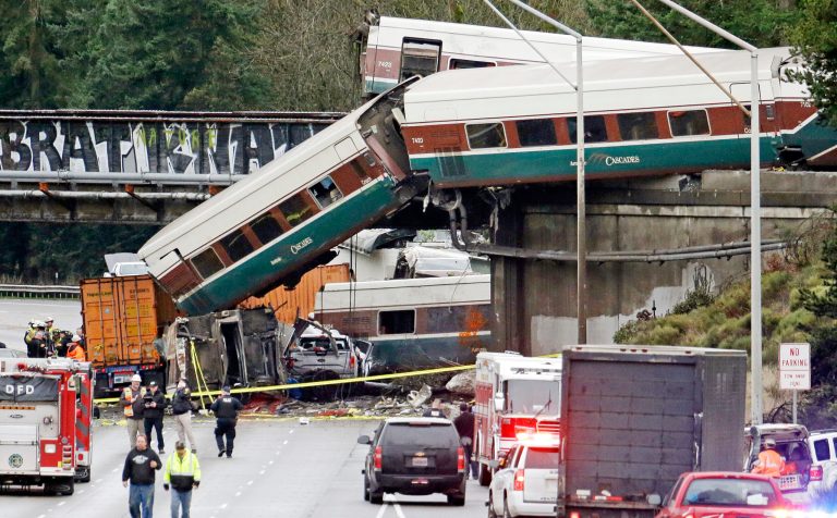 Cars from an Amtrak train lay spilled onto Interstate 5 below on Dec. 18 in DuPont, Washington. The Amtrak train was making its first-ever run along a faster new route. (AP Photo/Elaine Thompson)