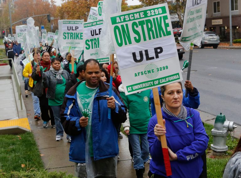 University of California hospital employees picketed medical centers across the state in response to what union leaders called intimidation and harassment from management against workers who took part in a two-day walkout in May.  The May strike came after the union's contract expired and negotiations over a new deal failed. (AP Photo/Rich Pedroncelli)