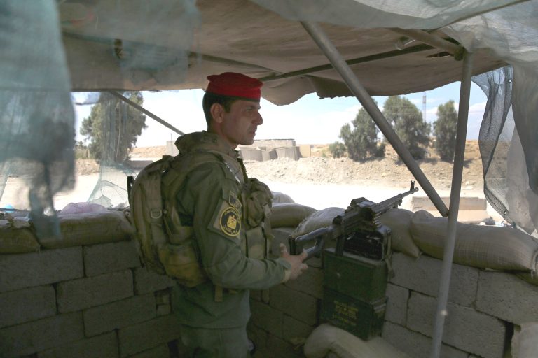 An Iraqi Army soldier stands guard as fellow troops assault ISIL fighters on the frontline on April 14, 2015 near Al-Karmah, in Anbar Province, Iraq. (Photo by John Moore/Getty Images)