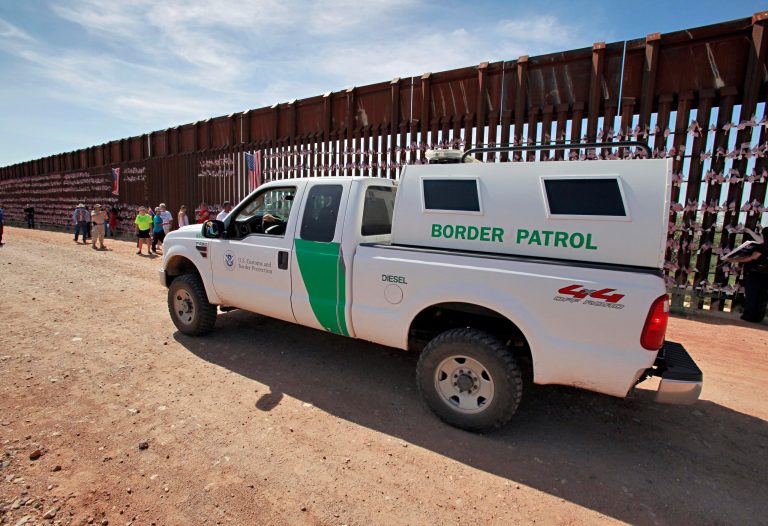 A U.S. Customs and Border Patrol agent patrols along the Arizona-Mexico border wall in Hereford, Ariz., in August 2010. (AP Photo/Matt York)