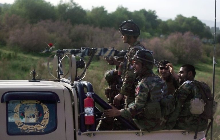 In this Sunday, April 12, 2015 photo, Afghan National Army soldiers patrol a road in Herat city, west of capital Kabul. (AP Photo/Massoud Hossaini)