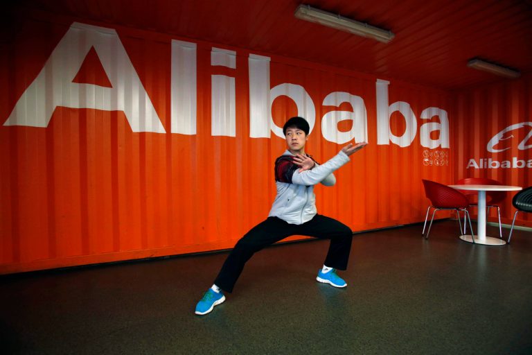 FILE - In this file photo taken Tuesday March 26, 2013, a worker performs shadow boxing during an open day at the Alibaba Group office in Hangzhou in east China's Zhejiang province. Alibaba Group is aiming to raise $1 billion in a long-awaited IPO likely to have ripple effects across the Internet. The Tuesday, May 6, 2014 filing sets the stage for the technology industry's biggest initial public offering since short messaging service Twitter and its early investors collected $1.8 billion in its stock market debut last fall.  (AP Photo) CHINA OUT