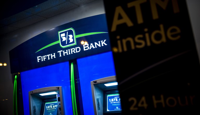 A Fifth Third Bancorp automatic teller machine (ATM) stands illuminated at night in Chicago, Illinois, U.S., on Friday, July 14, 2017. Fifth Third Bancorp is scheduled to release earnings figures on July 21.
