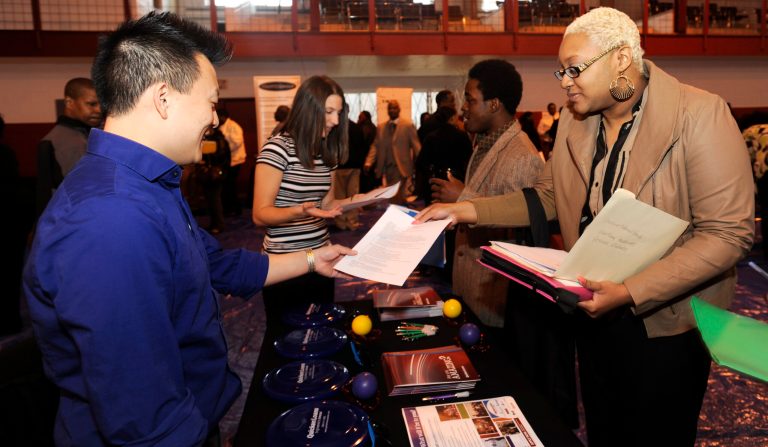 In this April 23, 2014 photo, Luke Gill, of Quicken Loans, left, talks with job candidate Jasmine Boykins at a job fair at the Matrix Center in Detroit. The government issues ist May jobs report on Friday, June 6, 2014. (AP Photo/The Detroit News, David Coates)