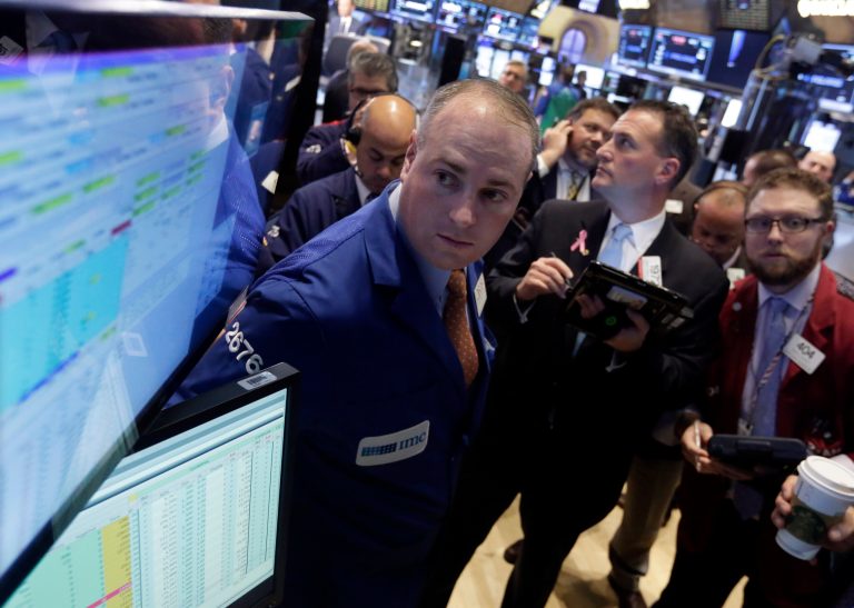 Traders gather at the post of specialist Edward Loggie, left, as they wait for shares of Orbital Sciences Corporation to resume trading, on the floor of the New York Stock Exchange, Wednesday afternoon, Oct. 29, 2014. Orbital Sciences Corporation sank following news that its Antares rocket exploded moments after lifting off from its launch pad on Tuesday. The rocket was carrying a supply ship for astronauts on the International Space Station, part of Orbital's contract with NASA. (AP Photo/Richard Drew)