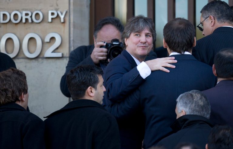 FILE - In this June 9, 2014 file photo, Argentina's Vice President Amado Boudou looks back as he enters a federal court in Buenos Aires, Argentina. The Vice President is back in court, this time over false data in the papers of an old car that he bought about 20 years ago. Boudou appeared before a federal judge Wednesday, July 23, 2014, and presented a written statement instead of speaking on his defense. Boudou is accused of transferring a Honda CRX automobile to his name irregularly in 2003. (AP Photo/Natacha Pisarenko, File)