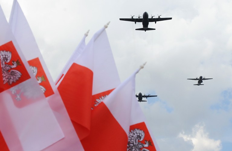 Polish Air Force C-130 Hercules aircrafts fly over Poland's national flags during a military parade marking Polish Armed Forces Day, in Warsaw, Poland, Friday, Aug. 15, 2014. Poland is holding its biggest military parade in years with tanks and soldiers moving through central Warsaw and military aircraft flying overhead. The parade comes on the August 15 holiday that honors a stunning Polish victory against Russian Bolsheviks in 1920. (AP Photo/Alik Keplicz)