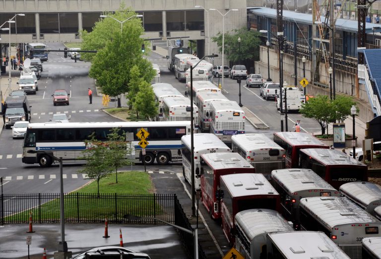 Shuttle buses line up to transport commuters at the transportation center in Bridgeport, Ct., Monday, May 20, 2013. The commuters had arrived from New Haven by train and were being bused to Stamford, Ct., where rail service to New York was available. A train collision on Friday injured 72 people and disrupted rail service into New York City. (AP Photo/Mark Lennihan)