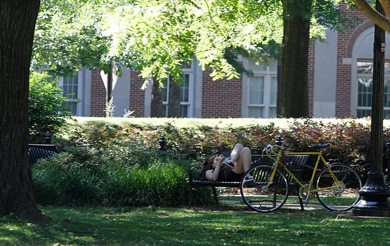 A student reads a book on the quad of the University of Alabama. (AP Photo/Butch Dill)