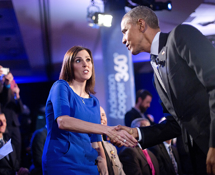 President Barack Obama, right, walks over to greet Taya Kyle, left, widow of U.S. Navy SEAL Chris Kyle, during a commercial break at a CNN televised town hall meeting at George Mason University in Fairfax, Va., Thursday. (AP Photo/Pablo Martinez Monsivais)