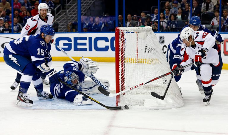 Tampa Bay Lightning defenseman Brian Lee (15) deflects a wraparound-attempt by Washington Capitals' Jay Beagle in front of goalie Mathieu Garon during the first period of an NHL hockey game on Thursday, Feb. 14, 2013, in Tampa, Fla. (AP Photo/Mike Carlson)