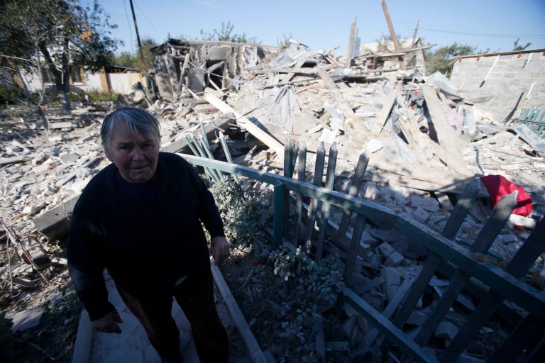 A woman observes damage at a destroyed home after shelling in the town of Donetsk, eastern Ukraine, Monday, Sept. 29, 2014. Eastern Ukraine has suffered the worst violence in more than a week as fighting between pro-Russian rebels and government troops in the region killed at least 12 people and wounded over 30, officials said Monday. (AP Photo/Darko Vojinovic)