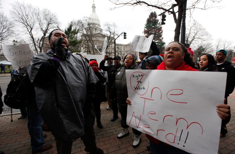   Demonstrators protest right-to-work legislation in the outside the George W. Romney State Office building, where Gov. Snyder's office is located, in Lansing, Mich., Friday, Dec. 7, 2012. Michigan could become the 24th state with a right-to-work law next week. Rules require a five-day wait before the House and Senate vote on each other's bills; lawmakers are scheduled to reconvene Tuesday and Gov. Snyder has pledged to sign the bills into law. (AP Photo/Paul Sancya)  