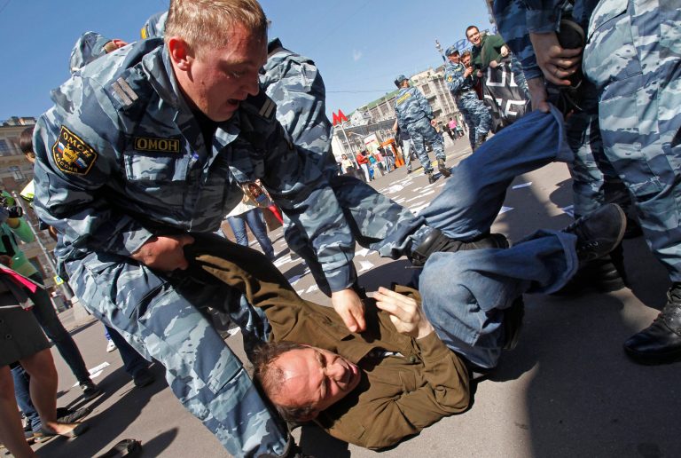   Russian police detain protesters outside the parliament building in Moscow, Russia, Tuesday, June 5, 2012. At least two dozen people have been detained outside Russian Parliament in Moscow as they were protesting against a bill on public rallies. The Kremlin-controlled Russian parliament is expected to pass a legislation on Tuesday that would raise fines 200-fold for taking part in unsanctioned rallies. Opposition leaders say that the law would also exacerbate tensions in the Russian society and leave the public with no free leeway of expressing their discontent. (AP Photo/Misha Japaridze)  