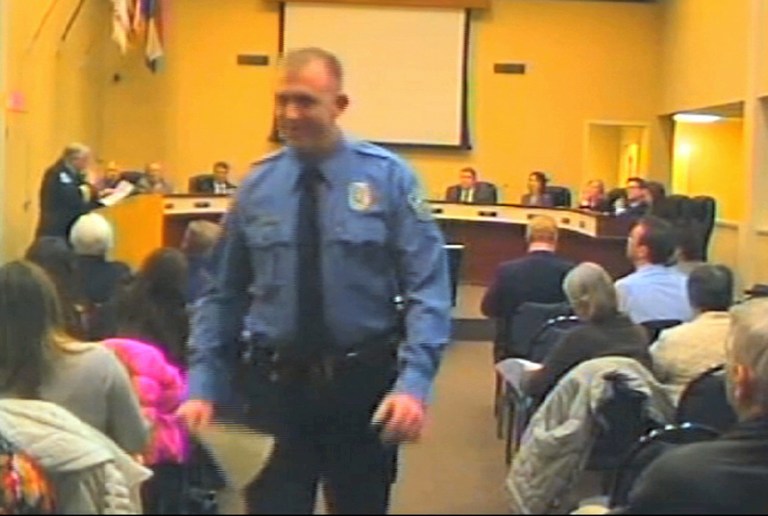 FILE - In this  Feb. 11, 2014 file image from video released by the City of Ferguson, Mo., officer Darren Wilson attends a city council meeting in Ferguson. Wilson has told authorities that Michael Brown reached for the gun during a scuffle, the Times reported in a story posted on its website Friday night Oct. 17, 2014.   (AP Photo/City of Ferguson, File)
