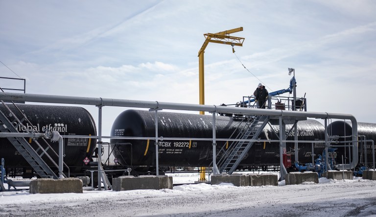A worker prepare a train car to be loaded with ethanol.