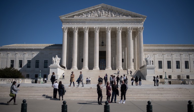Visitors stand outside the U.S. Supreme Court in Washington, D.C.