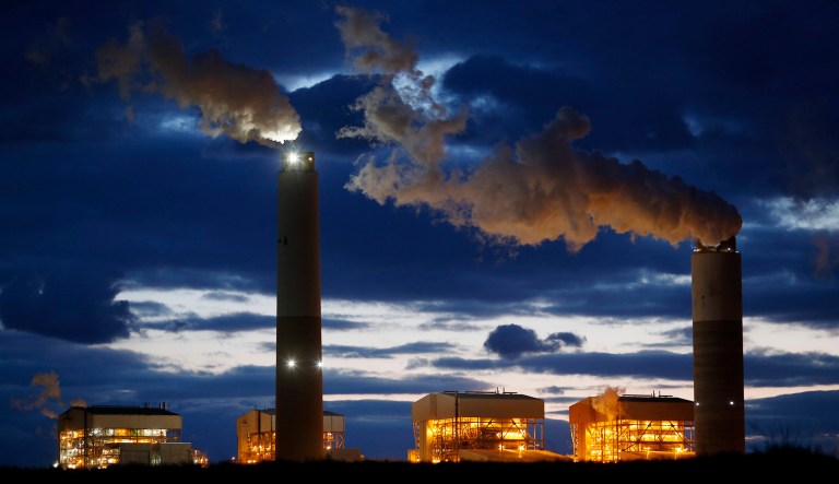 Emissions rise from the coal fired Santee Cooper Cross Generating Station power plant at dusk in Pineville, South Carolina, U.S., on Wednesday, March 21, 2018. Construction of new coal plants around the world fell for the second year in a row in 2017 as the world's biggest polluters began to restrict new projects and explore other technologies.