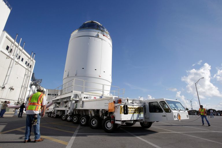 NASA's Orion spacecraft, preparing for it's first flight,  departs the Neil Armstrong Operations and Checkout Building on its way to the Payload Hazardous Servicing Facility at the Kennedy Space Center, Thursday, Sept. 11, 2014, in Cape Canaveral, Fla. Orion is scheduled for a test flight in early December. (AP Photo/John Raoux)