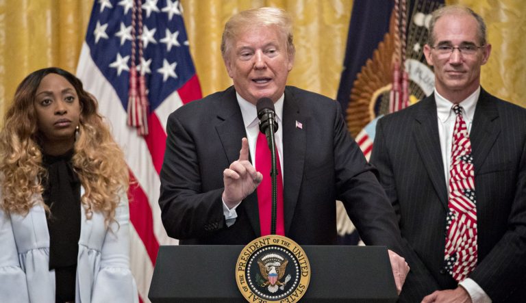 U.S. President Donald Trump, center, speaks during an event to mark the sixth-month anniversary of the Tax Cuts and Jobs Act passage in the East Room of the White House in Washington, D.C., U.S., on Friday, June 29, 2018. 