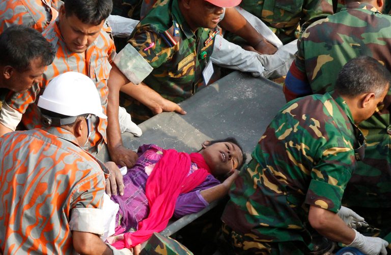 Rescuers carry a survivor pulled out from the rubble of a building that collapsed in Saver, near Dhaka, Bangladesh, Friday, May 10, 2013. Rescue workers in Bangladesh freed the woman buried for 17 days inside the wreckage of a garment factory building that collapsed, killing more than 1,000 people. Soldiers at the site said her name was Reshma and described her as being in remarkably good shape despite her ordeal. (AP Photo)
