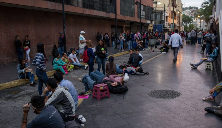 People wait in line to apply for passports at the Administrative Service of Identification, Migration, and Foreigners (SAIME) in Caracas, Venezuela, on Tuesday, Sept. 18, 2018.