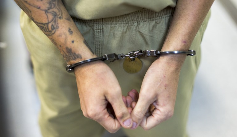 An inmate stands handcuffed at the Bayamon 705 correctional facility in Bayamon, Puerto Rico, on Wednesday, Sept. 26, 2018.