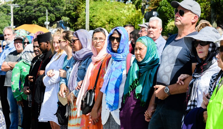 People gather to honor the victims of the Christchurch terrorist attack outside the Kilbernie Mosque in Wellington, New Zealand, on Friday, March 22, 2019. Radio and television stations across New Zealand broadcast the Muslim call to prayer followed by two minutes of silence as the nation stopped to honor the 50 people killed and more than 40 wounded in last week's mosque attacks.