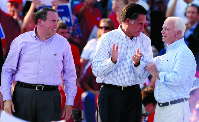 Conservatives are pushing for Mike Huckabee to be Mitt Romney's running mate. The two are shown here with Sen. John McCain (Photo by Whitney Curtis/Getty Images)
