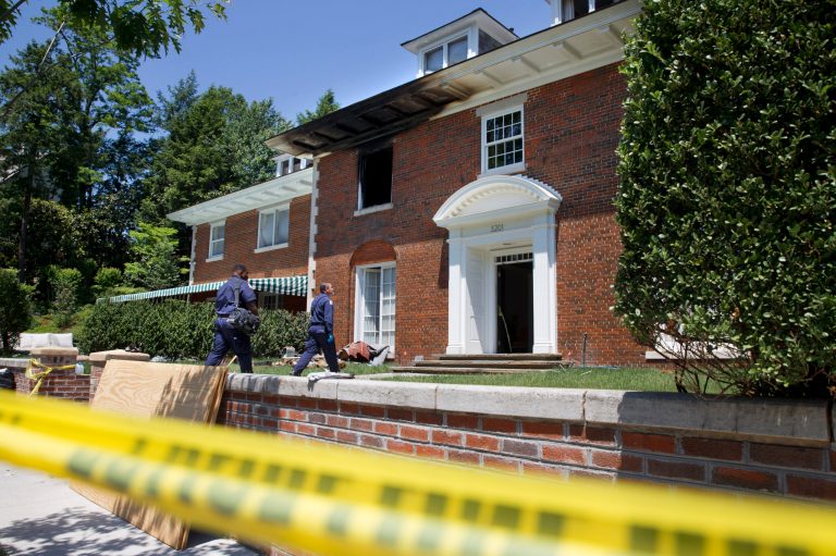 Pictured above is the fire-damaged multimillion-dollar home in northwest Washington home where four people were killed in May.Â The 