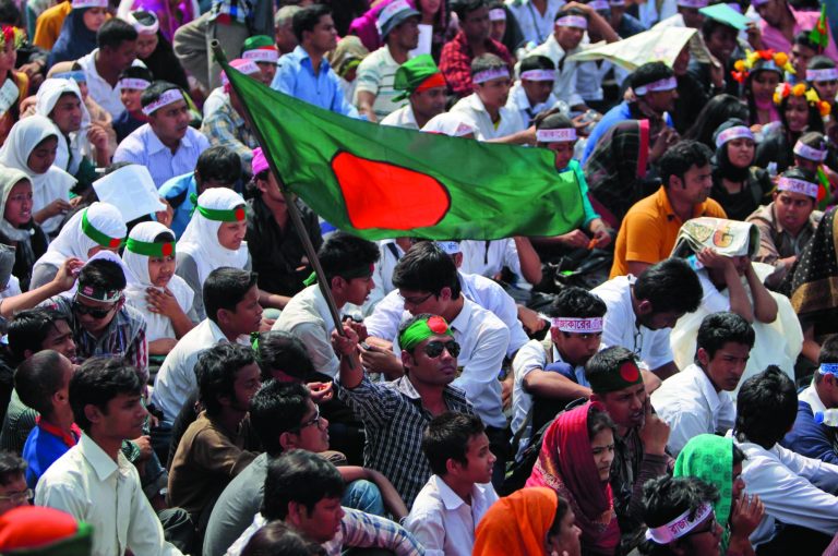 FILE - In this Wednesday, Feb. 13, 2013 file photo, Bangladeshi activists participate in a rally demanding the execution of Jamaat-e-Islami leader Abdul Quader Mollah and others convicted of war crimes in Dhaka, Bangladesh. For many in Bangladesh, the ''V'' for victory sign was more than they could bear. They had waited more than four decades for justice in the mass killings and rapes during their independence war. But there was a smiling Mollah apparently celebrating his life sentence - given in place of an expected death sentence - for his role in the killing of 381 civilians. Within hours, thousands of university students demanding his death poured into the streets of Dhaka, the seeds of what has grown into a mass protest that has exposed again the unhealed wounds from the nation's 1971 war for independence from Pakistan. (AP Photo/A.M. Ahad, File)