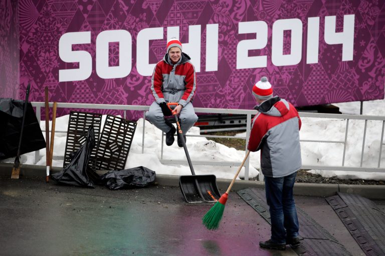 Two workers take a break at the Sanki Sliding Center, a venue for bobsleigh, skeleton and luge at the 2014 Winter Olympics, Friday, Jan. 31, 2014, in Krasnaya Polyana, Russia. (AP Photo/Jae C. Hong)