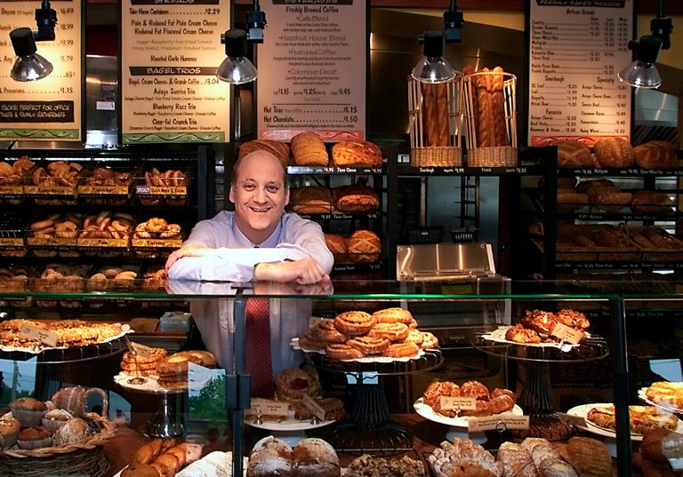 Panera Bread CEO Ron Shaich stands behind a counter at one of their stores. The chain is planning to overhaul its 